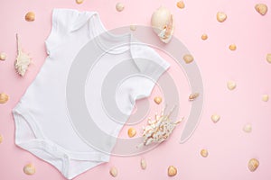 Mockup Flat Lay white baby bodysuit shirt on a pink background with a nautical theme, shells and the sea