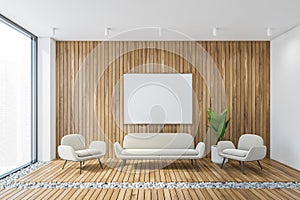 Mockup frame above white armchairs with sofa in wooden hall, wooden wall and rug