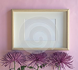 Mockup frame with chrysanthemum flowers on pink background.