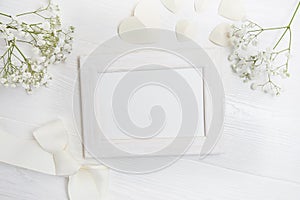 Mockup frame with flowers and bow greeting card for Valentines Day or wedding with place for your text. Flat lay, top