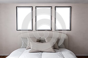 Mockup frame. Modern bedroom with three blank frames on wall, bed in neutral tones, minimalist design, spacious room, comfortable