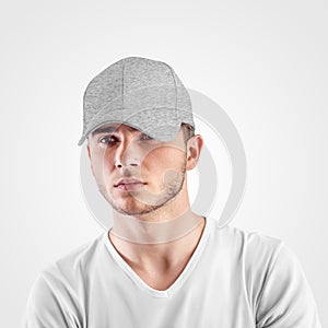 Mockup of gray baseball cap heather on a guy`s head, isolated on background