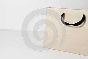 Mockup of grey paper shopping bag on neutral background with copy space