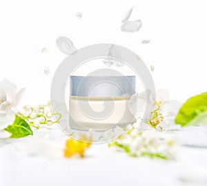 mockup of hand, facial or body cream with spring flowers, concept announcement sale or promotion new product