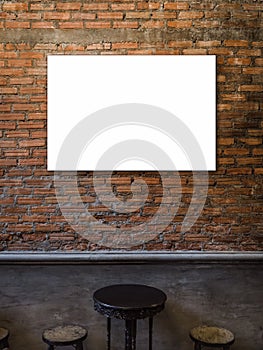 Mockup horizontal artist frame or white blank poster on red brick wall background over the empty vintage wooden round table.