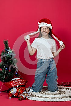 Mockup Image of an Asian Woman Wearing White Blank Shirt With Christmas Outer on a Red Background