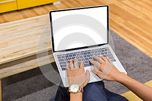 Mockup image of a businessman using laptop with blank white desktop screen working in home