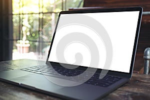 Mockup image of computer laptop with blank white desktop screen on wooden table