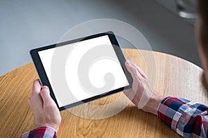 Mockup image of digital tablet computer with white blank screen in man hands