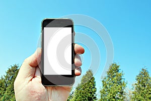 Mockup image of hand holding black mobile phone with blank white screen and green tree forest , nature background