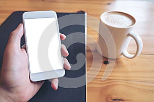 Mockup image of hand holding white mobile phone with blank screen with coffee cup on wooden table