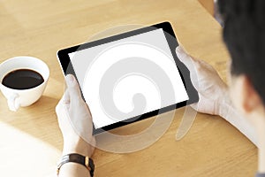 Mockup image of a man holding black color tablet device in hands