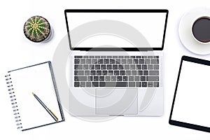 Mockup image of modern white office desk with laptop computer with blank screen, mobile digital tablet,