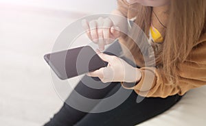 Mockup image of woman`s hands holding black mobile phone with blank screen in office