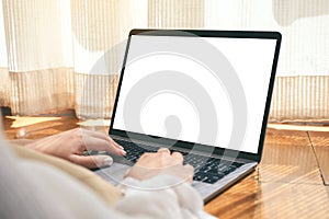 A woman using laptop computer with blank white desktop screen while laying down on the floor with feeling relaxed