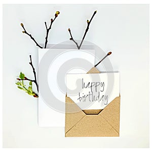 Happy birthday card. handmade invitation lists, craft envelope, on white background. Overhead view. Flat lay, top view photo