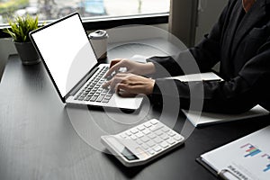 Mockup laptop, blank screen. Woman accountant using calculator and laptop in office