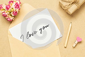 Mockup letter and envelop on craft wood with I love you text and kraft gift box. Mock up for elegant design. Flat lay top view
