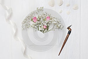 Mockup Letter with flowers and calligraphic pen greeting card for St. Valentine`s Day in rustic style with place for
