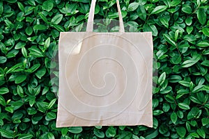 Mockup Linen Cotton Tote Bag on Green Bush Trees Foliage Background. Eco Nature Friendly. Environmental Conservation Recycling