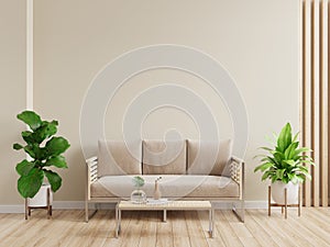Mockup living room interior with sofa on empty cream color wall background