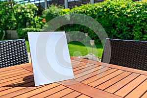 Mockup of a magazine cover on a wooden table in the garden in summer