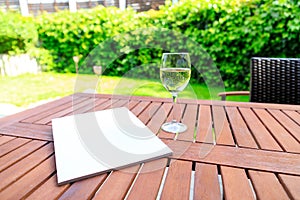 Mockup of a magazine cover on a wooden table in the garden in summer