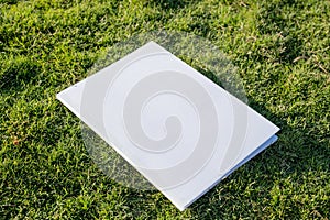 Mockup magazine on green grass background