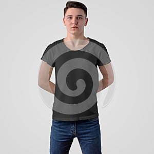 Mockup of a male black t-shirt on a guy, for the presentation of design and pattern and advertising in the online store, front