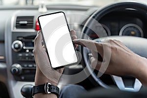 Mockup of man driver hand using blank white screen mobile smart phone inside a car, searching location via gps navigator