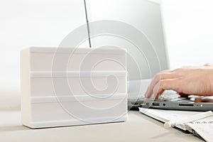 Mockup or mock-up. Workplace with a laptop, hands of a man, notepad on a white background. Freelancer& x27;s workplace