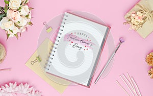 Mockup Notebook on pink background with Happy valentines day, roses bouquet, gift box, handy craft and pen. Mock up for elegant