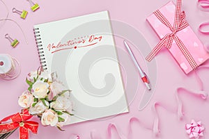 Mockup Notebook on pink background with red Happy valentines day, roses bouquet, gift box, handy craft and pen. Mock up for