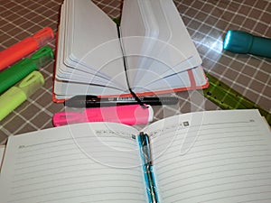 Mockup notepad, diary with pen, pencil, markers and a flashlight