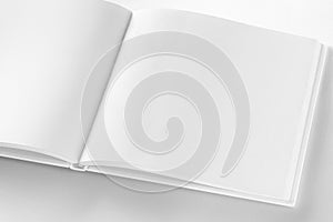 Mockup of opened blank square book at white design paper