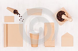 Mockup packing for coffee products and shop - brown paper cup, blank notebook, packet, label, card, mortar, coffee beans on white.