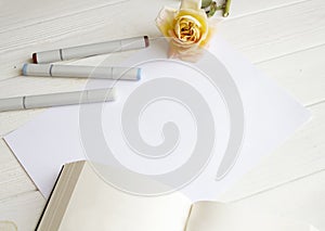 Mockup for A4 paper with single rose, book and drawing material