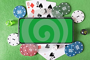 Mockup phone with chroma key and playing cards and poker chips in the casino