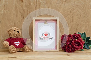 Mockup Picture frame and cute bear with Bouquet of red roses on rusty wood. Valentines Day Background concept with copy space.