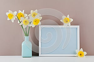 Mockup of picture frame decorated narcissus flowers in vase with empty space for text your blogging and greeting for mother day.