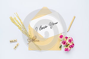 Mockup postcard and envelope on white background with craft rose flower. Mock up for elegant design. Flat lay top view valentine`s