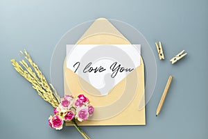 Mockup postcard and envelope on white background with craft rose flower. Mock up for elegant design. Flat lay top view valentine`s
