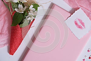 Mockup with postcard and jasmine on pink background. card and white flowers.waffle for ice cream, lip kiss