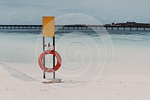 Mockup of safety banner on the beach with the lifebuoy