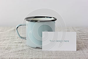 Mockup, scene creator with a business card and a blue enameled mug