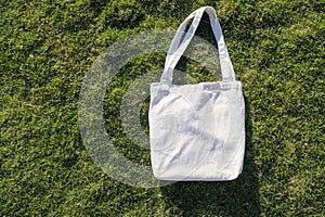 Mockup shopper handbag on green grass background