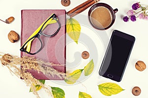 Mockup with smartphone and autumn decoration. Autumn time for reading