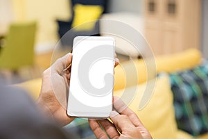 Mockup smartphone on businessman hands empty display on home table with blur background. - Image - Image