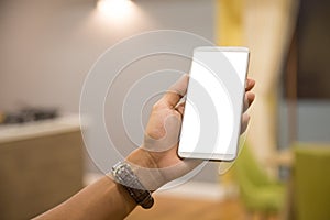 Mockup smartphone on businessman hands empty display on home table with blur background. - Image - Image