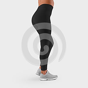 Mockup of sportswear on fit female legs, side view, empty black leggings for presentation of design and advertising in the online